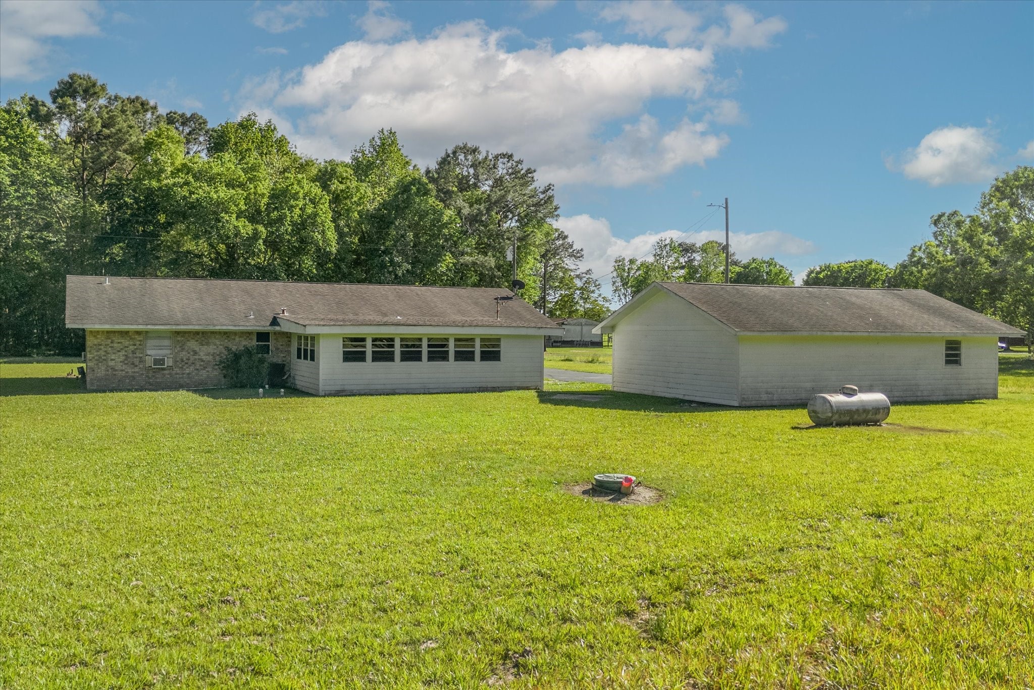 411 County Road 2298 Cleveland, TX 77327 - Photo 39 of 47 a view of an outdoor space and basketball court