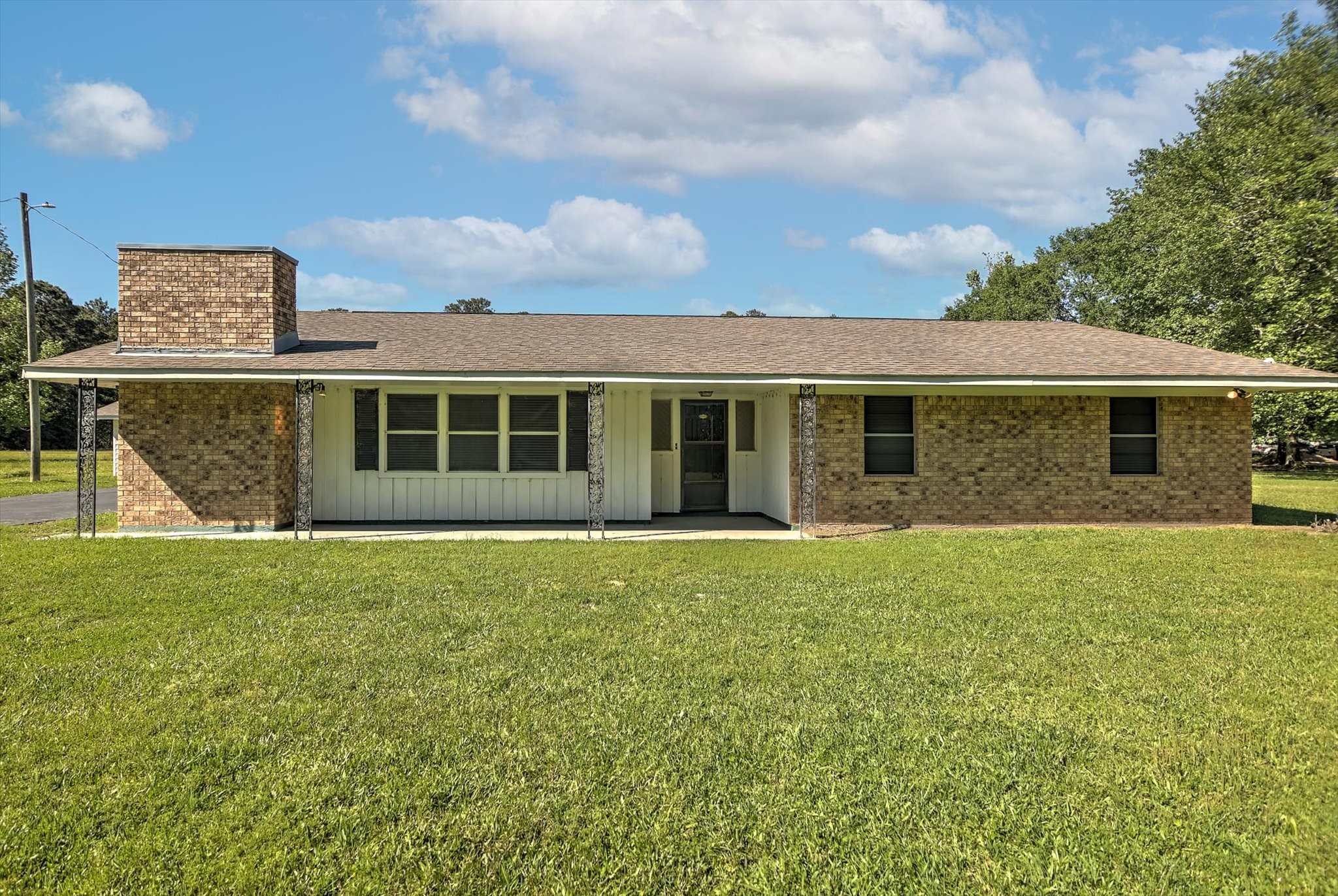 411 County Road 2298 Cleveland, TX 77327 - Photo 4 of 47 a front view of a house with a garden