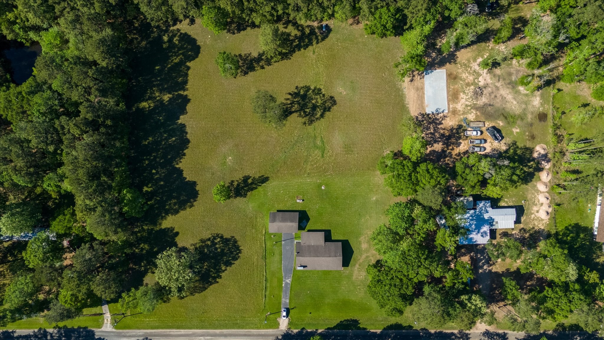 411 County Road 2298 Cleveland, TX 77327 - Photo 41 of 47 an aerial view of a residential houses with outdoor space and trees all around
