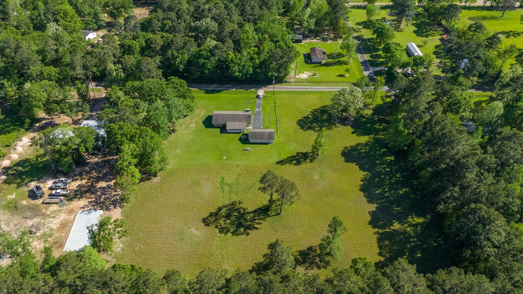 411 County Road 2298 Cleveland, TX 77327 - Photo 43 of 47 a view of a lake with a house