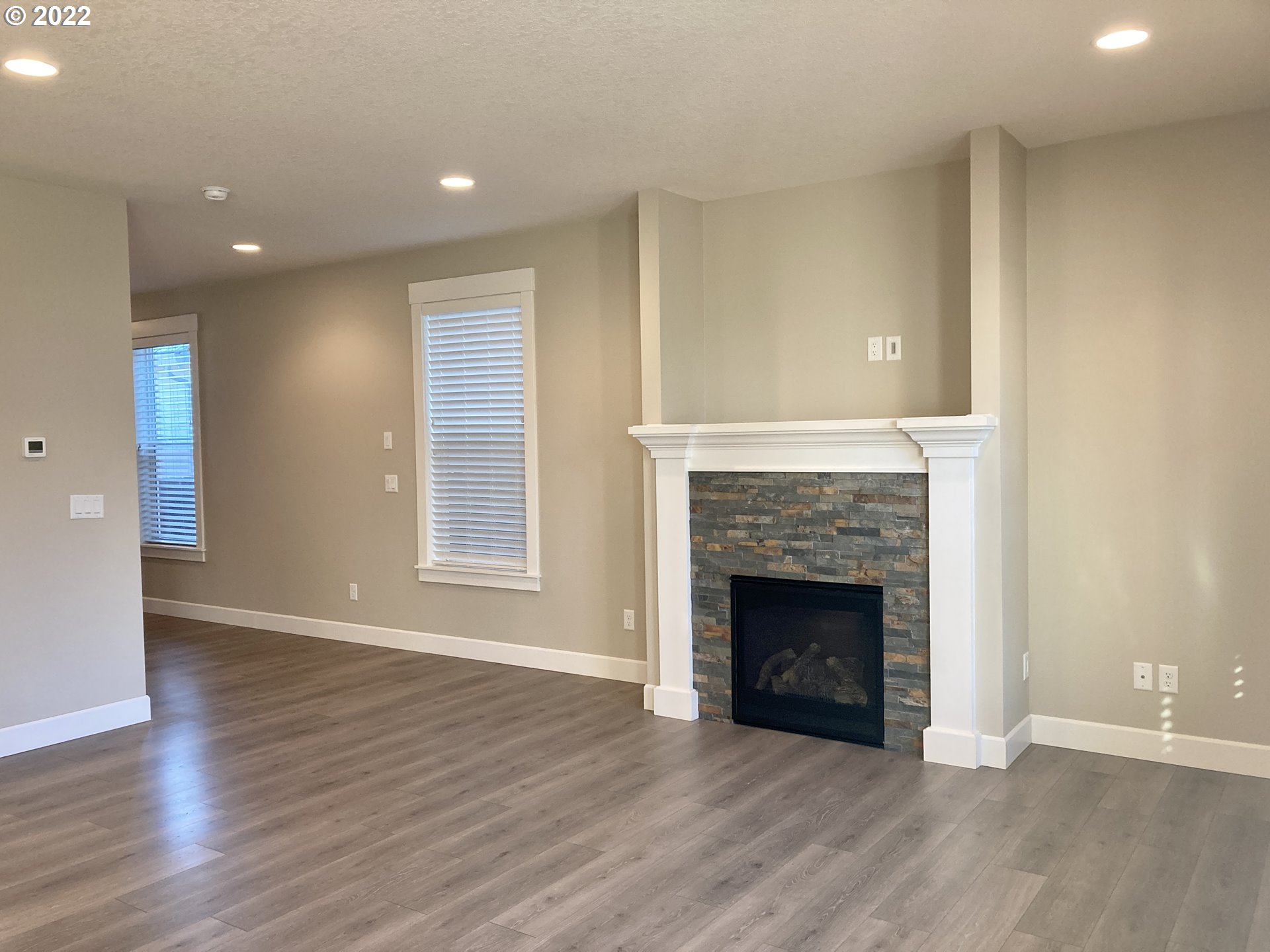 1201 South Quail Run Place Ridgefield, WA 98642 - Photo 11 of 27 a view of an empty room with wooden floor and a fireplace