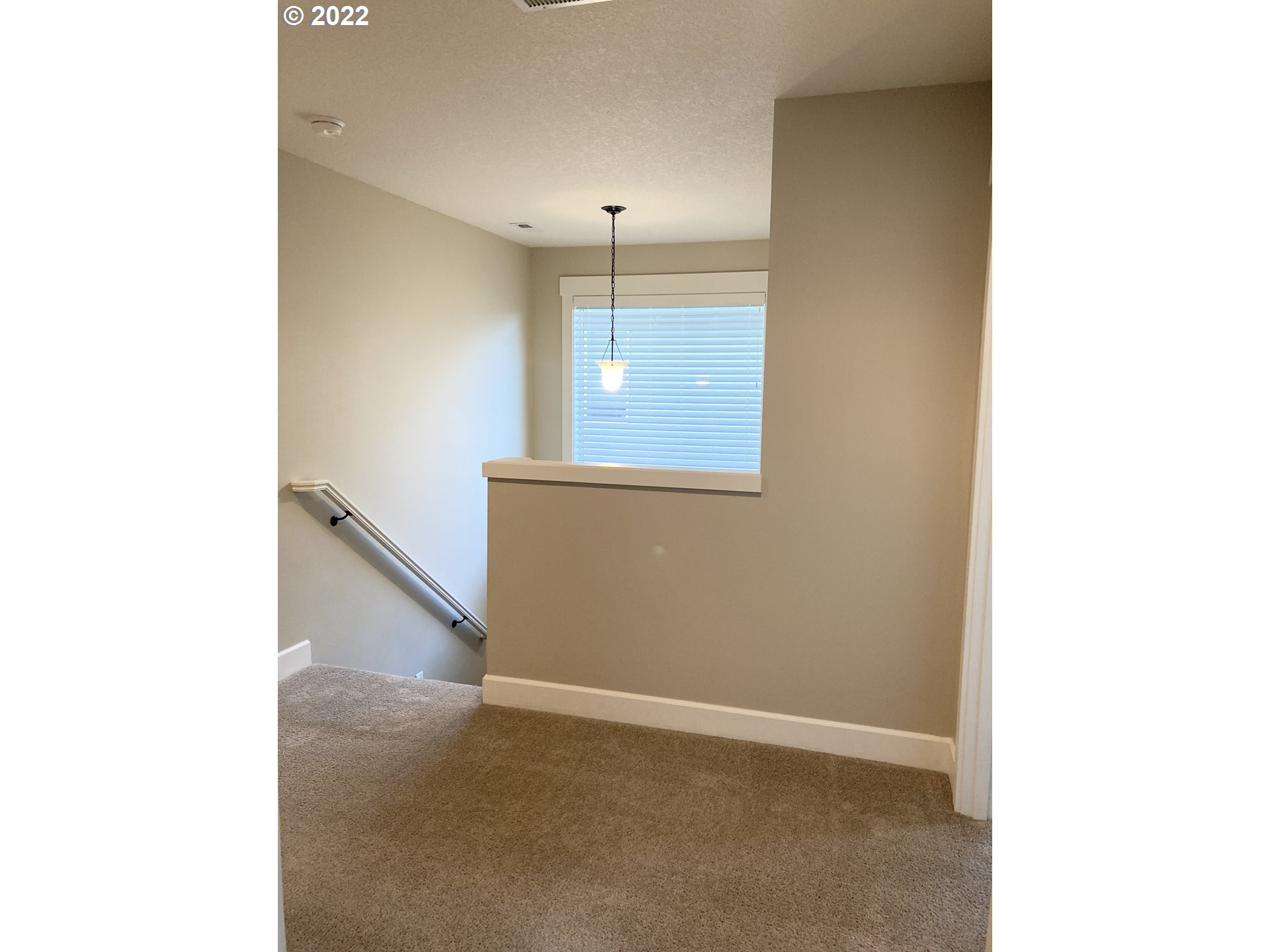 1201 South Quail Run Place Ridgefield, WA 98642 - Photo 13 of 27 a view of an empty room with wooden floor