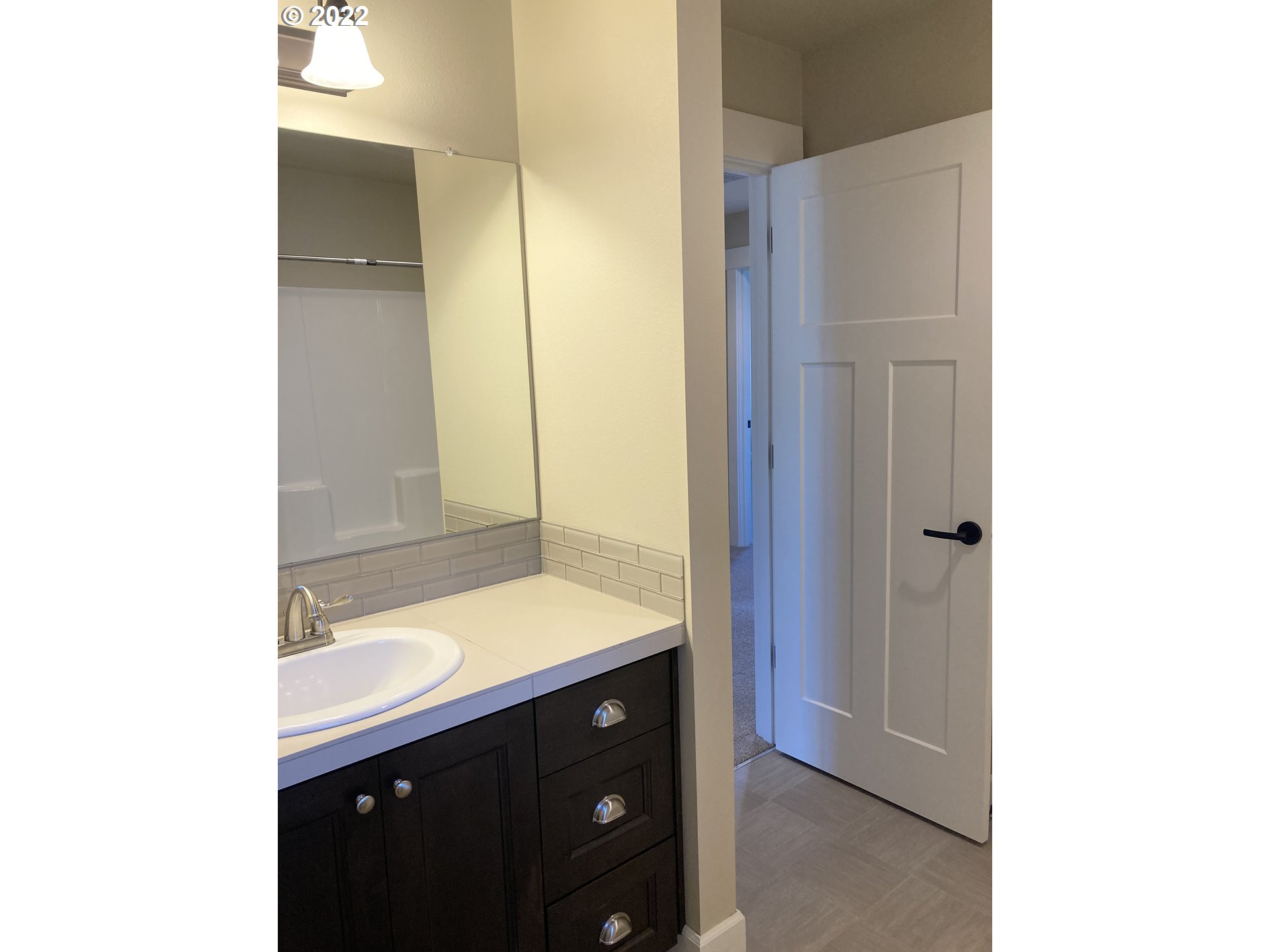 1201 South Quail Run Place Ridgefield, WA 98642 - Photo 20 of 27 a bathroom with a sink and a mirror