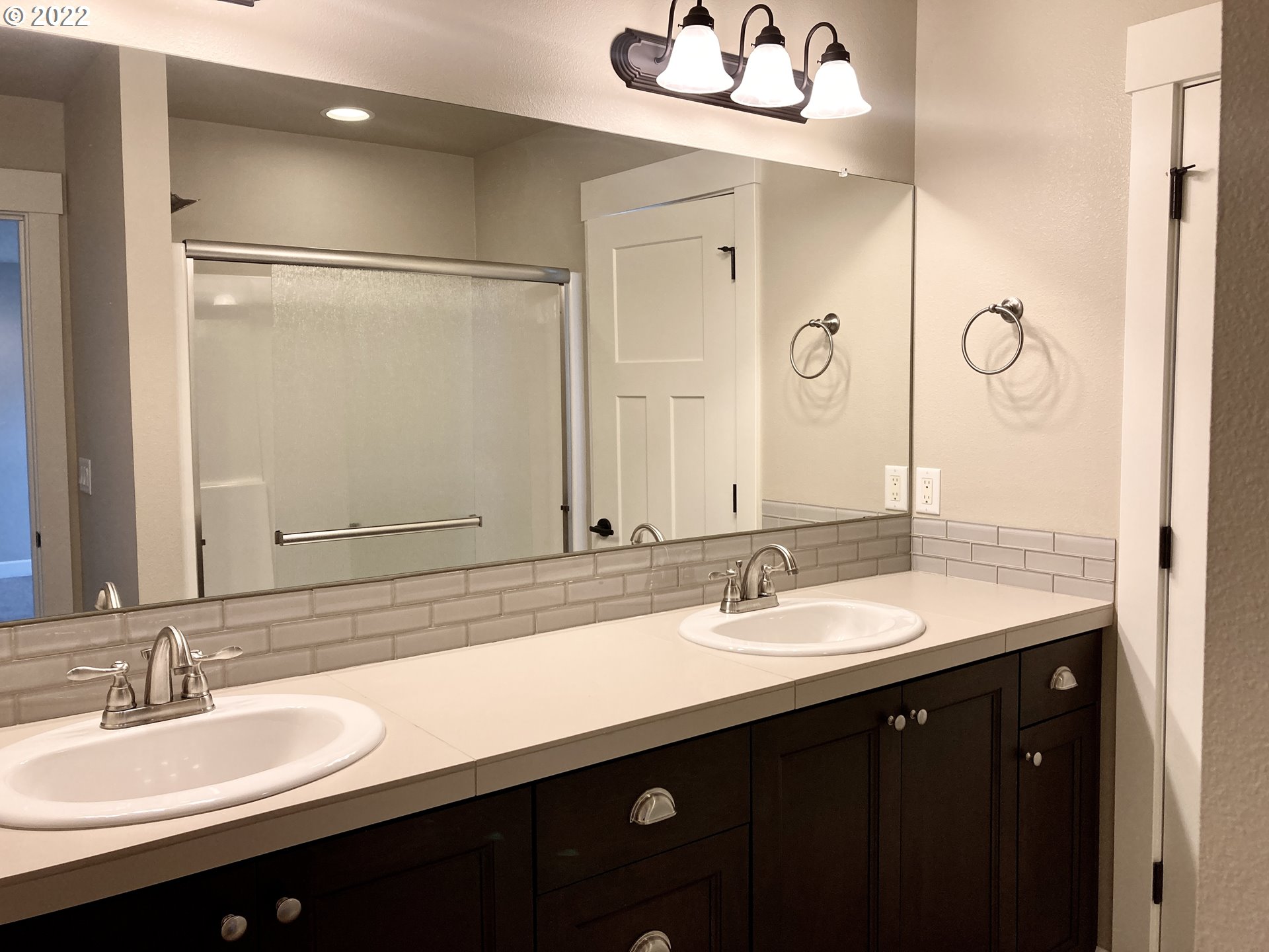 1201 South Quail Run Place Ridgefield, WA 98642 - Photo 24 of 27 a bathroom with a double vanity sink and mirror