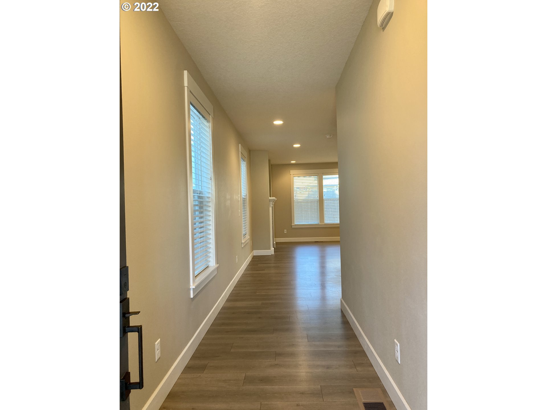 1201 South Quail Run Place Ridgefield, WA 98642 - Photo 4 of 27 a view of a hallway with wooden floor