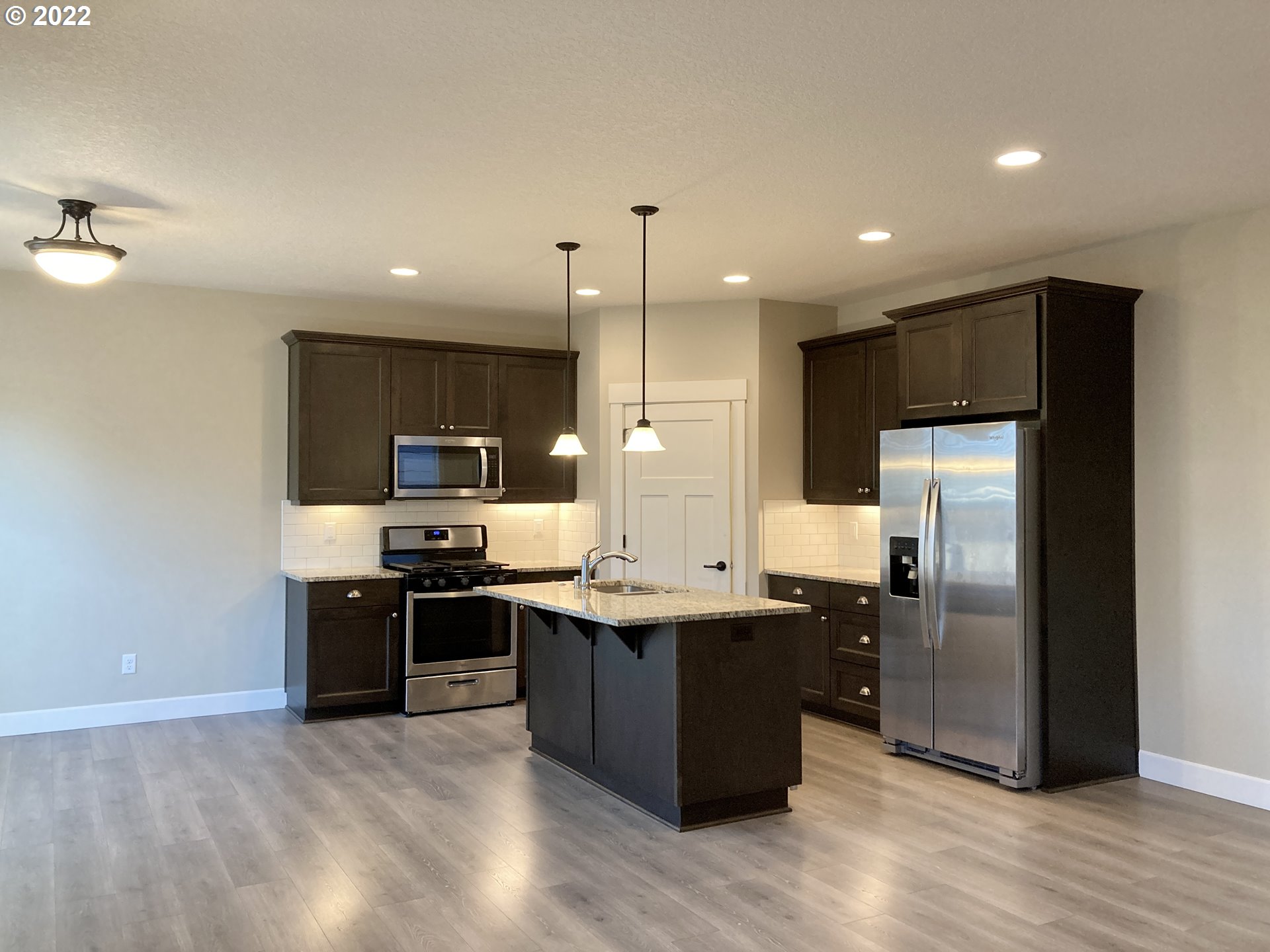 1201 South Quail Run Place Ridgefield, WA 98642 - Photo 7 of 27 a kitchen with stainless steel appliances granite countertop a sink stove and refrigerator