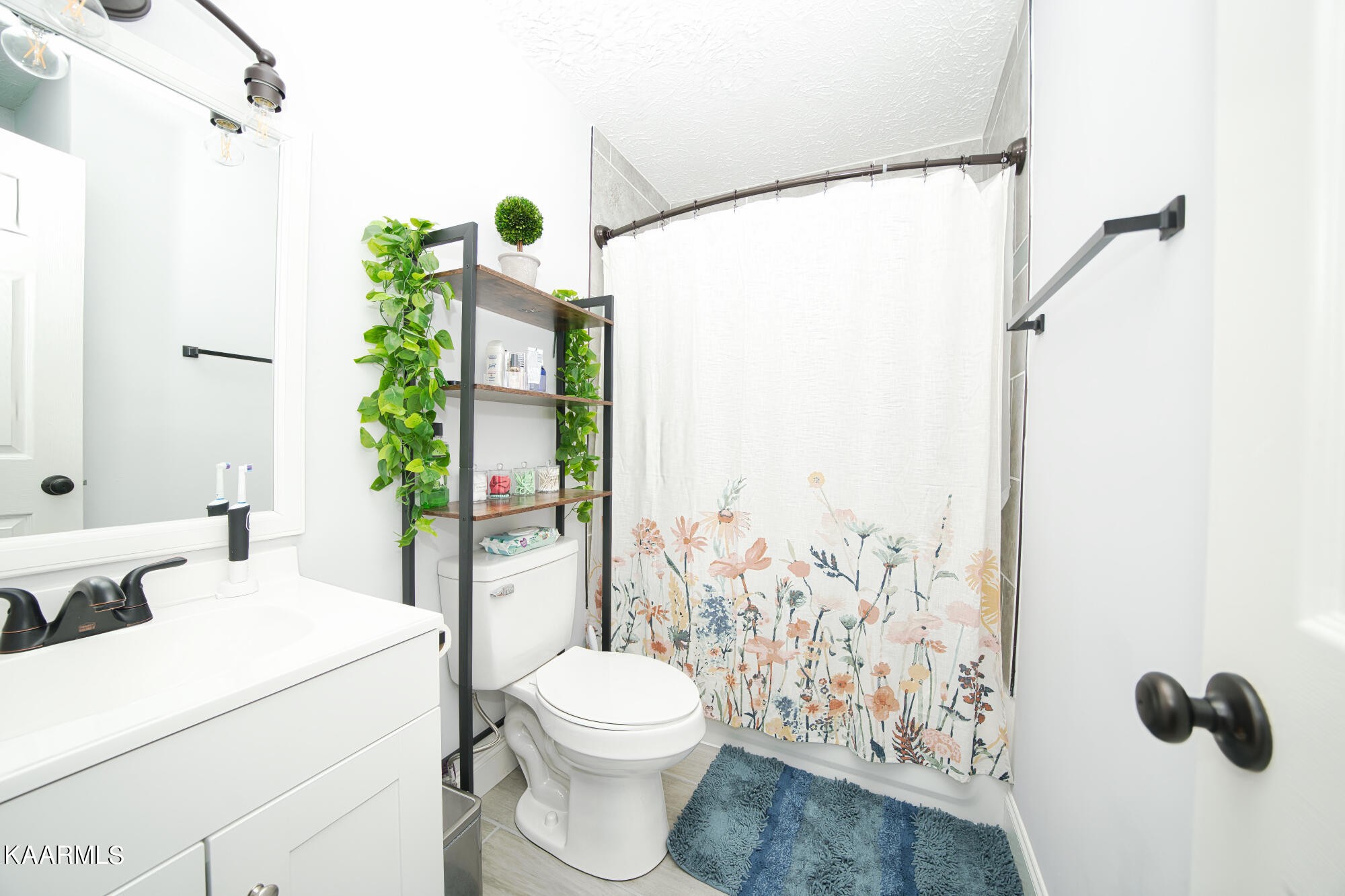 1519 Cunningham Road Knoxville, TN 37918 - Photo 8 of 16 a bathroom with a toilet and a shower curtain