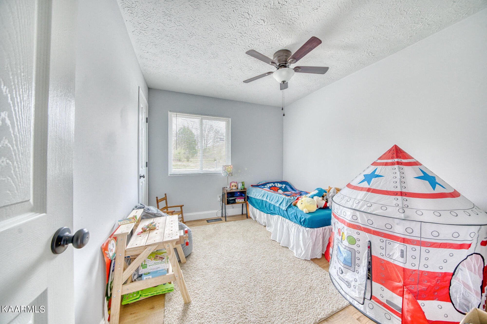 1519 Cunningham Road Knoxville, TN 37918 - Photo 10 of 16 a bedroom with a bed and a chandelier