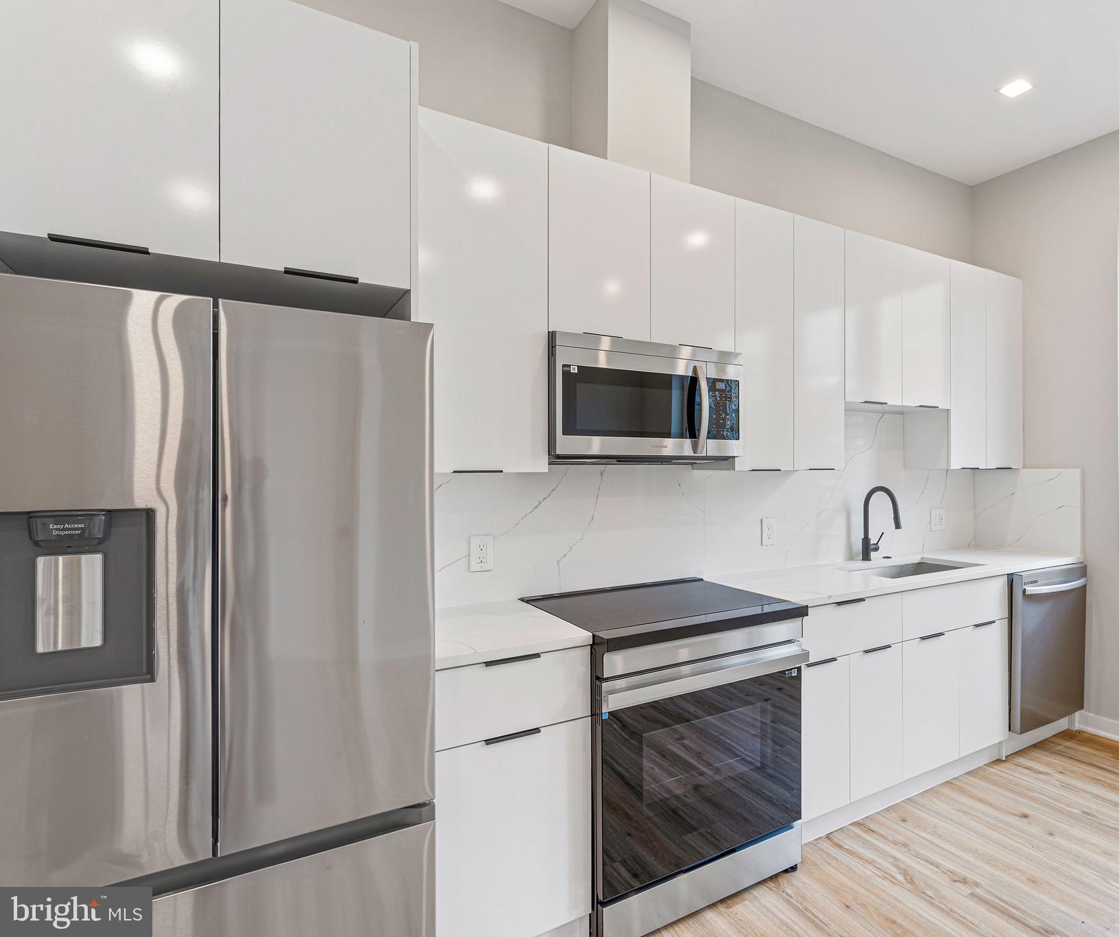 1358 Florida Avenue Northeast, Unit 207 Washington, DC 20002 - Photo 2 of 15 a kitchen with stainless steel appliances a refrigerator sink and microwave