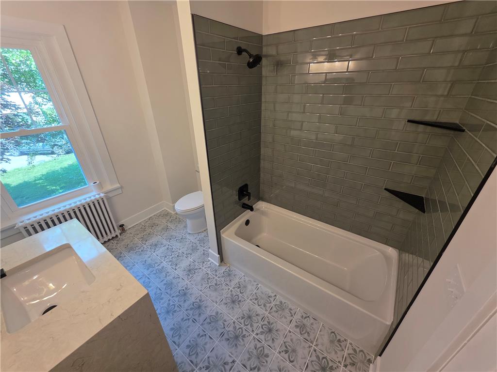 601 Cherry Hill Road Nazareth, PA 18064 - Photo 18 of 27 Elegant gray subway tile creates a sophisticated backdrop for this functional bathroom's tub and vanity.