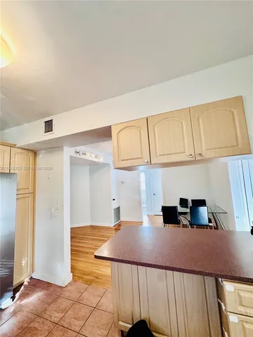 a large kitchen with a large counter top a stove and a refrigerator