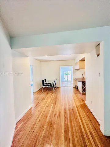 a view of a living room hardwood and kitchen