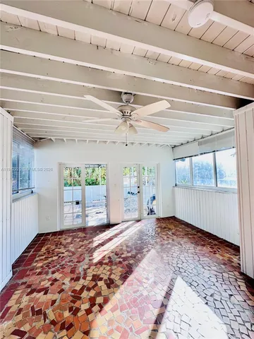 a view of a room with window and hardwood floor