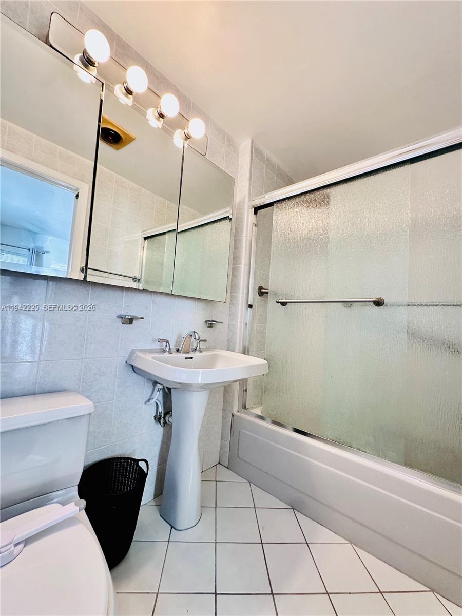 1180 Southwest 22nd Terrace, Unit 1 Miami, FL 33129 - Photo 22 of 32 a bathroom with a sink toilet and shower