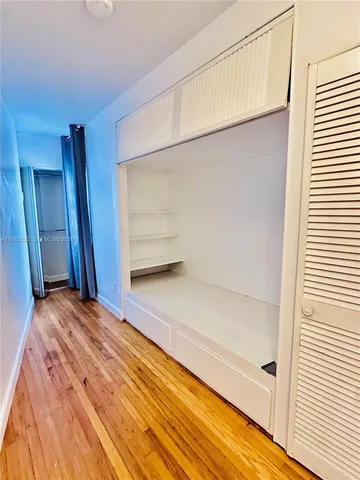 a car parked in front of a white house