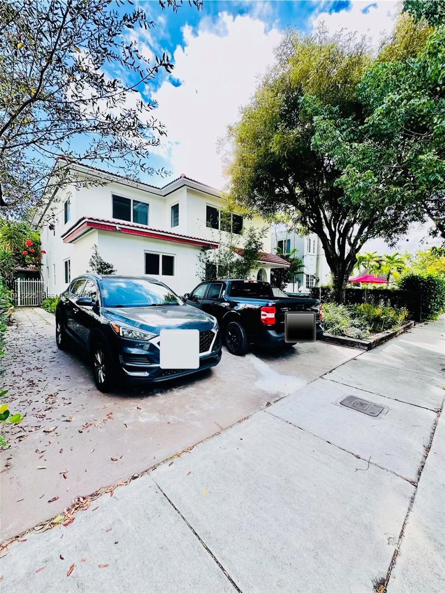 1180 Southwest 22nd Terrace, Unit 1 Miami, FL 33129 - Photo 32 of 32 a car parked in front of a white house