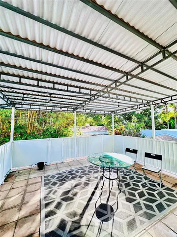 a living room with stainless steel appliances kitchen island granite countertop a sink and cabinets
