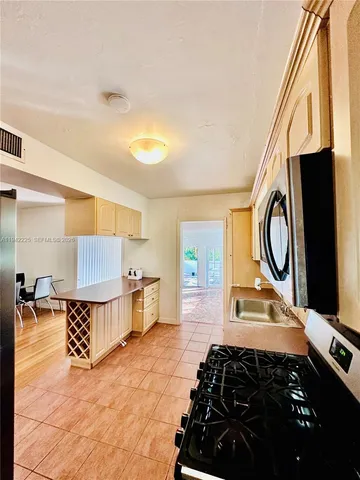 a kitchen with a sink and a stove top oven