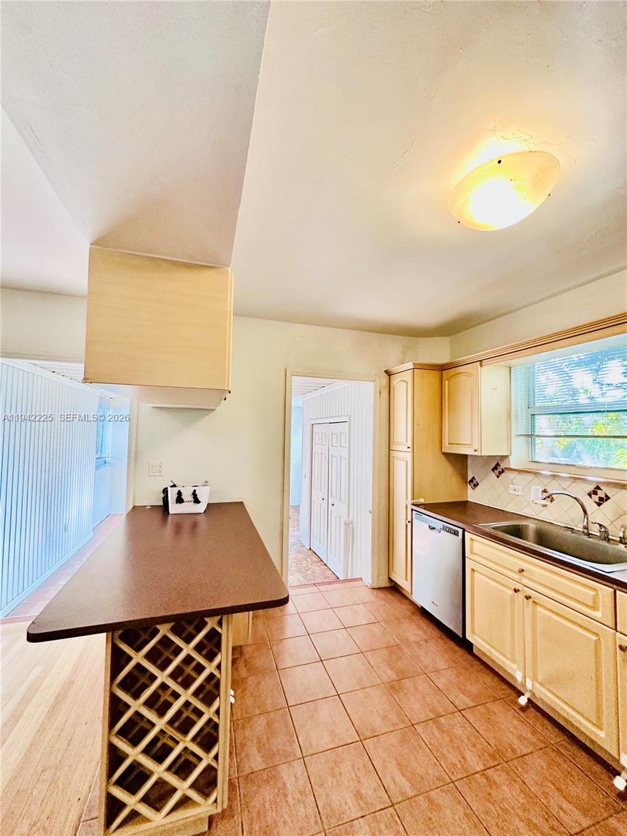 1180 Southwest 22nd Terrace, Unit 1 Miami, FL 33129 - Photo 10 of 32 a kitchen with a sink and a stove top oven