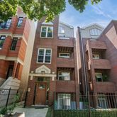 a front view of a residential apartment building with a yard