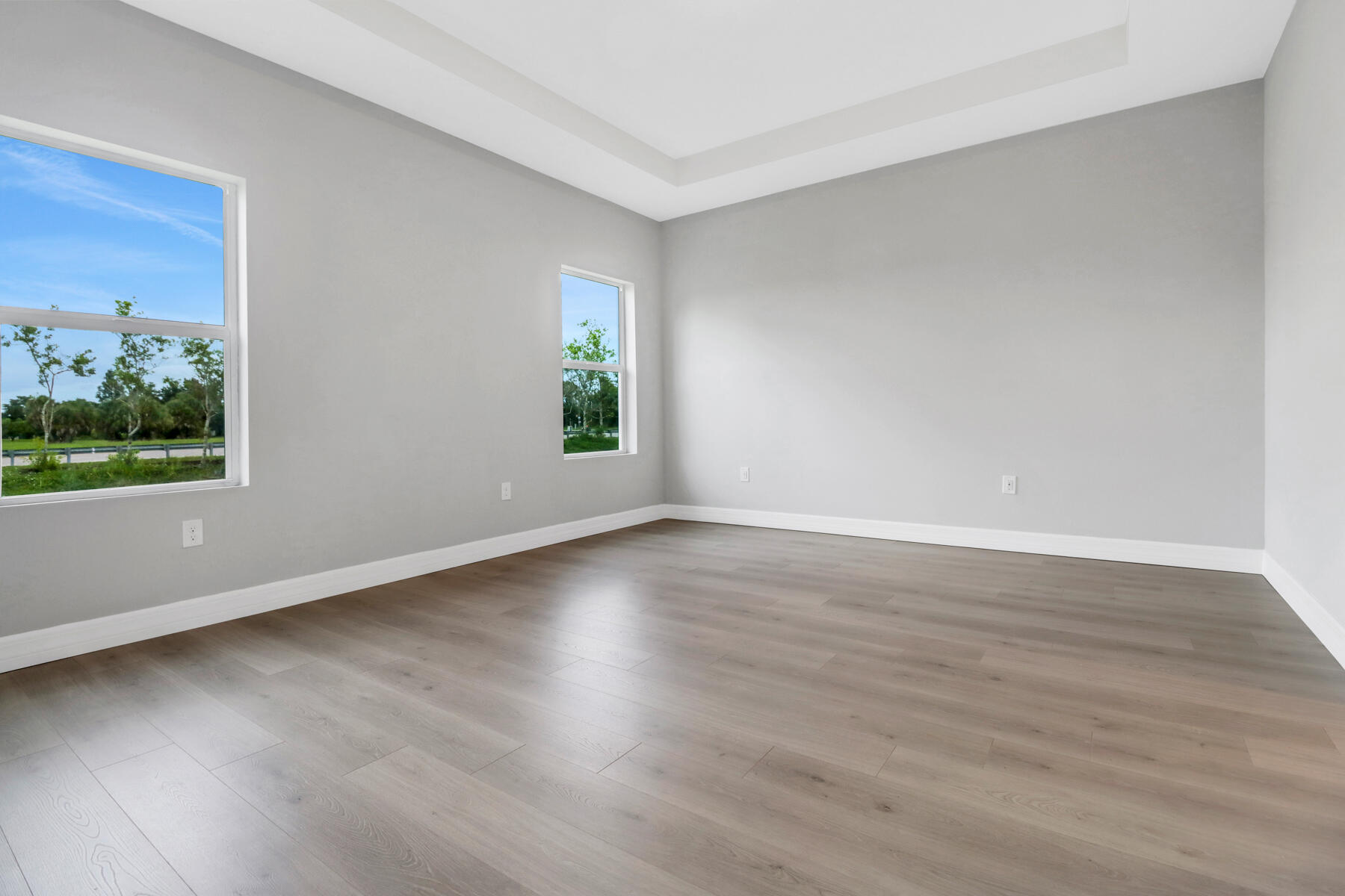 23158 Ranger Avenue Port Charlotte, FL 33954 - Photo 13 of 25 a view of an empty room with wooden floor and a window