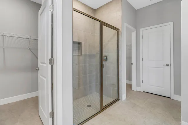 a bathroom with a glass shower door