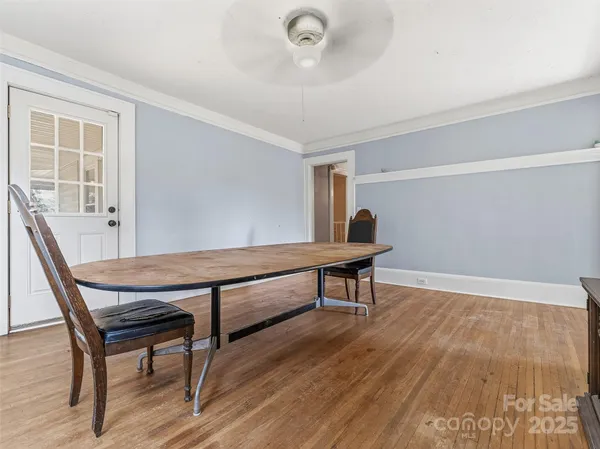 a view of room with wooden floor and furniture