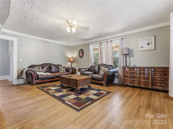 a living room with furniture a rug and a chandelier