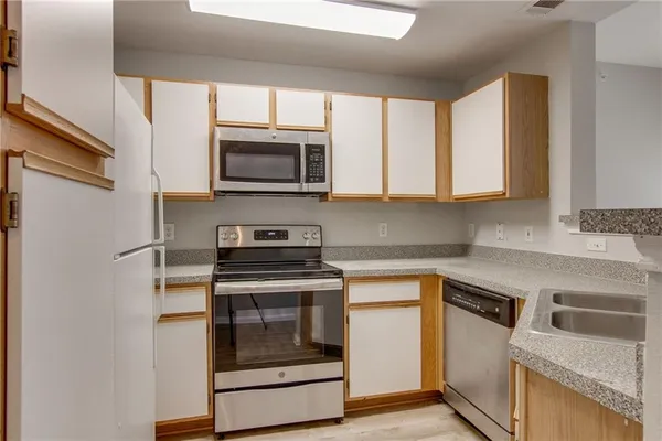 a view of a kitchen from a hallway