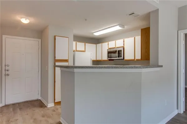 a view of a kitchen with a refrigerator and a sink