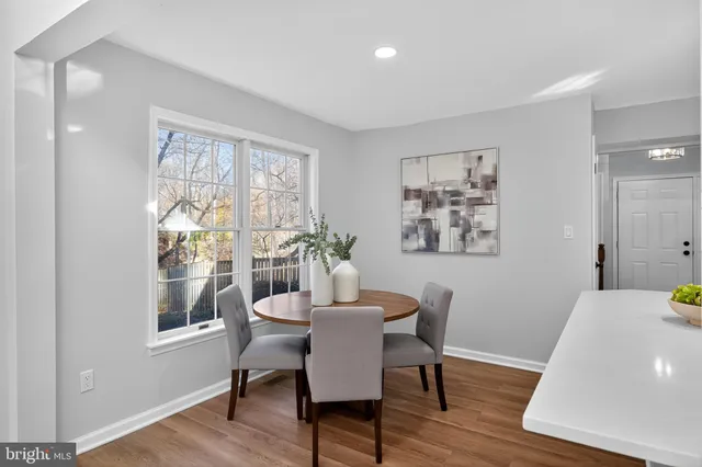 a dining room with furniture and wooden floor