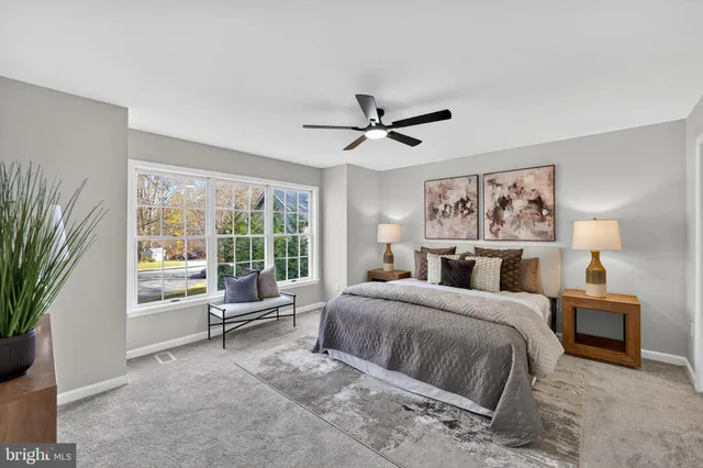 a bedroom with a large bed and a large window