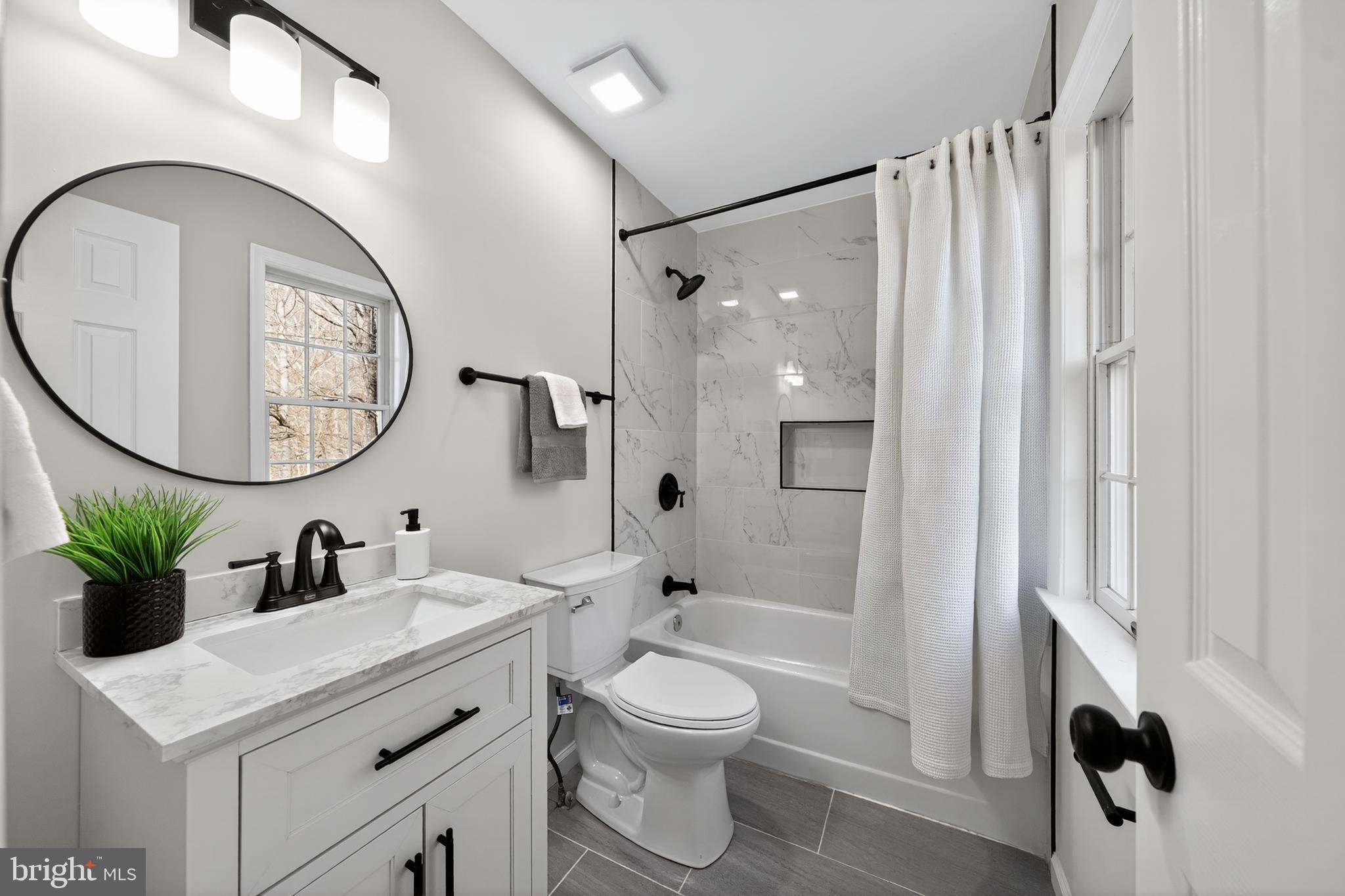 9310 Bellbeck Road Baltimore, MD 21234 - Photo 22 of 30 a bathroom with a sink a toilet and a mirror