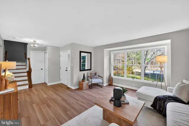 a bedroom with furniture and a large window