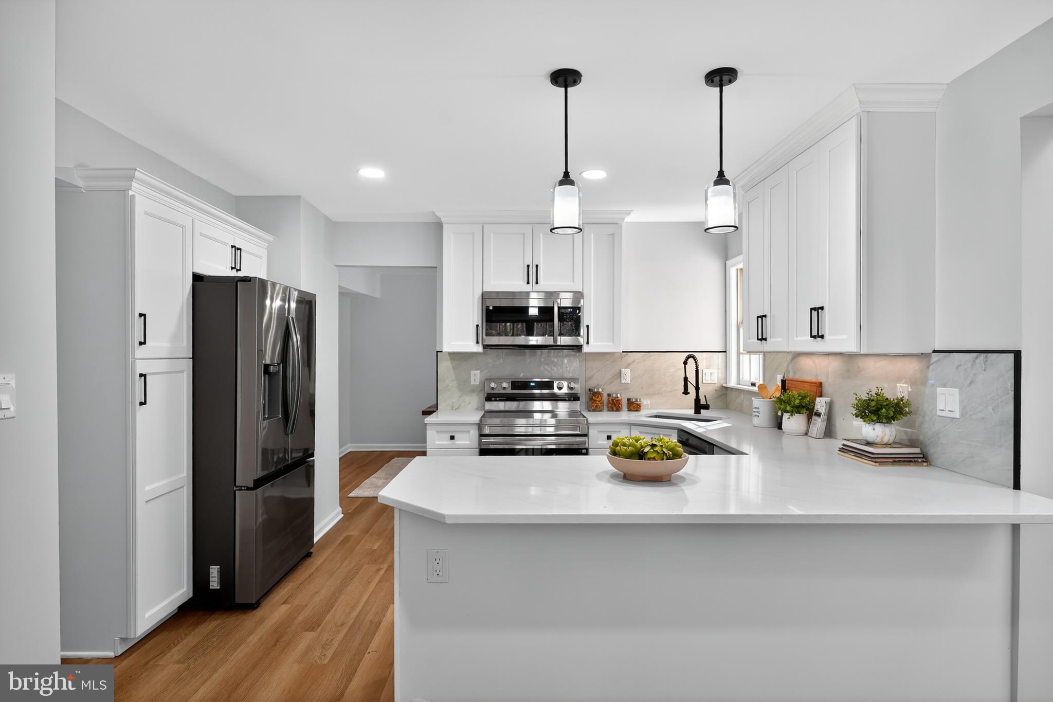 9310 Bellbeck Road Baltimore, MD 21234 - Photo 9 of 30 a kitchen with a refrigerator a stove and a sink
