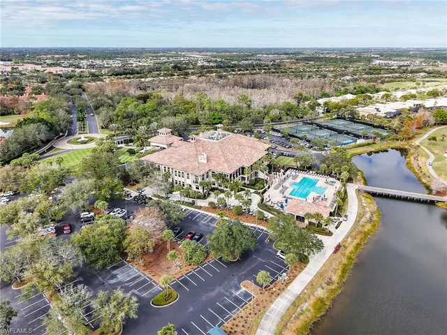 an aerial view of residential houses with outdoor space and swimming pool
