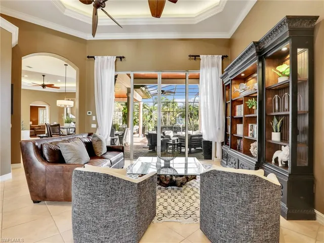 a living room with fireplace furniture and a floor to ceiling window