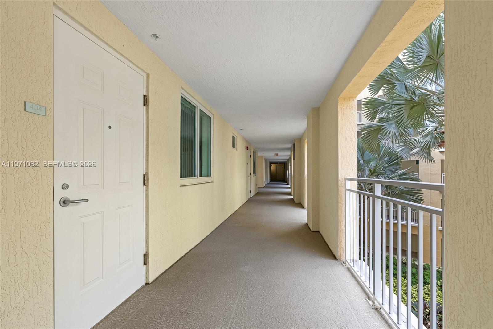 7275 Southwest 90th Way, Unit 404 Miami, FL 33156 - Photo 4 of 35 a view of a hallway with windows