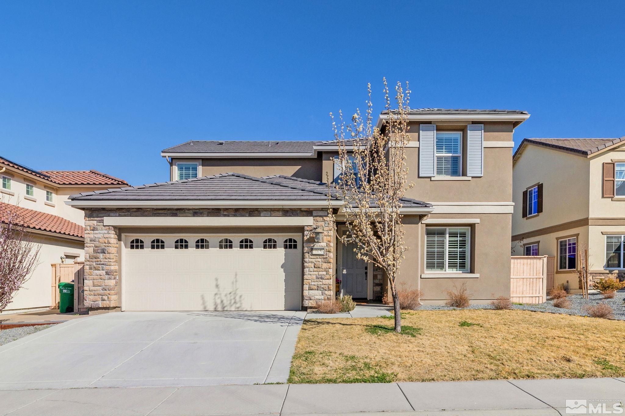 10656 Foxberry Park Drive Reno, NV 89521 - Photo 1 of 31 a front view of a house with a yard