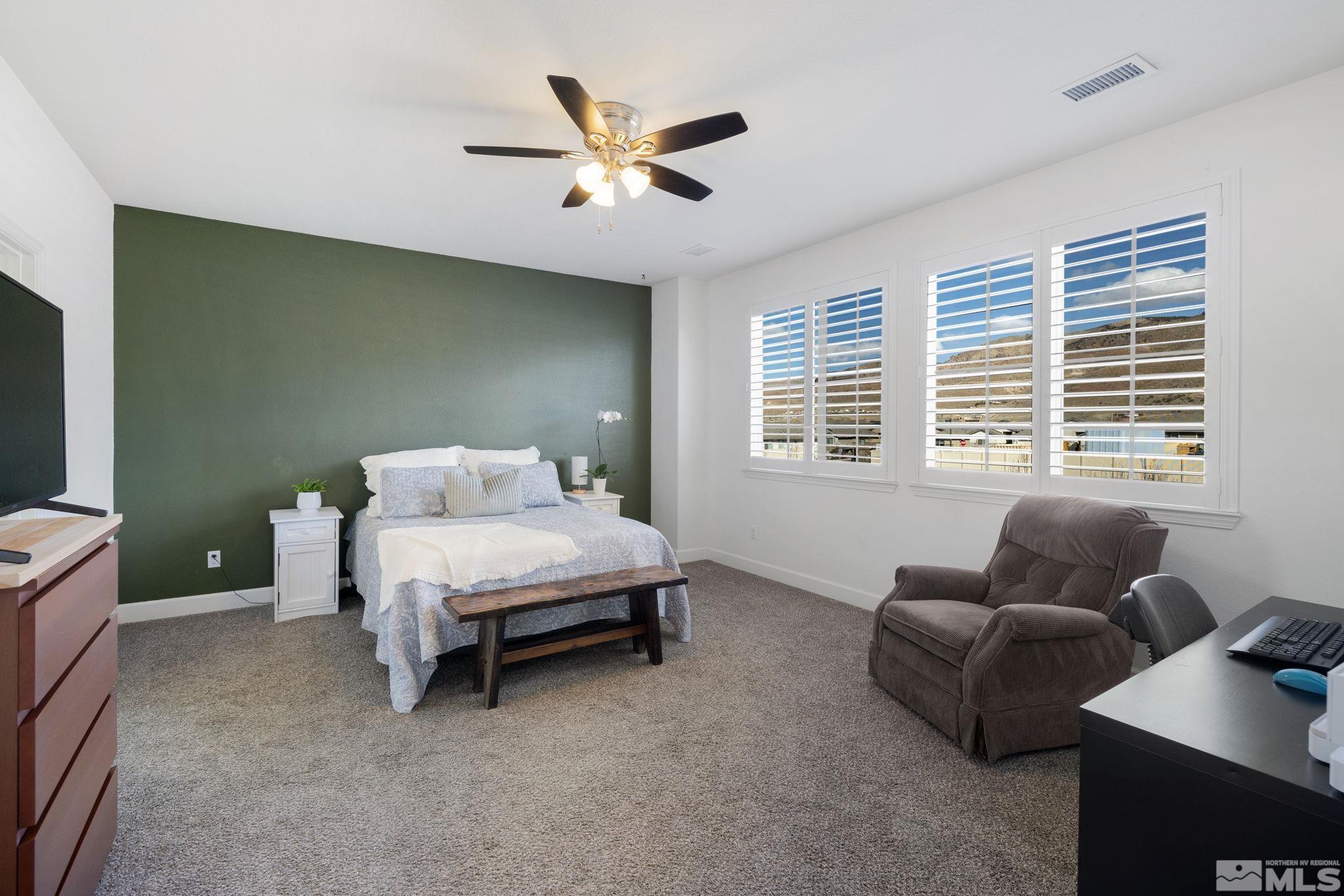 10656 Foxberry Park Drive Reno, NV 89521 - Photo 15 of 31 a bed room with a bed and a couch