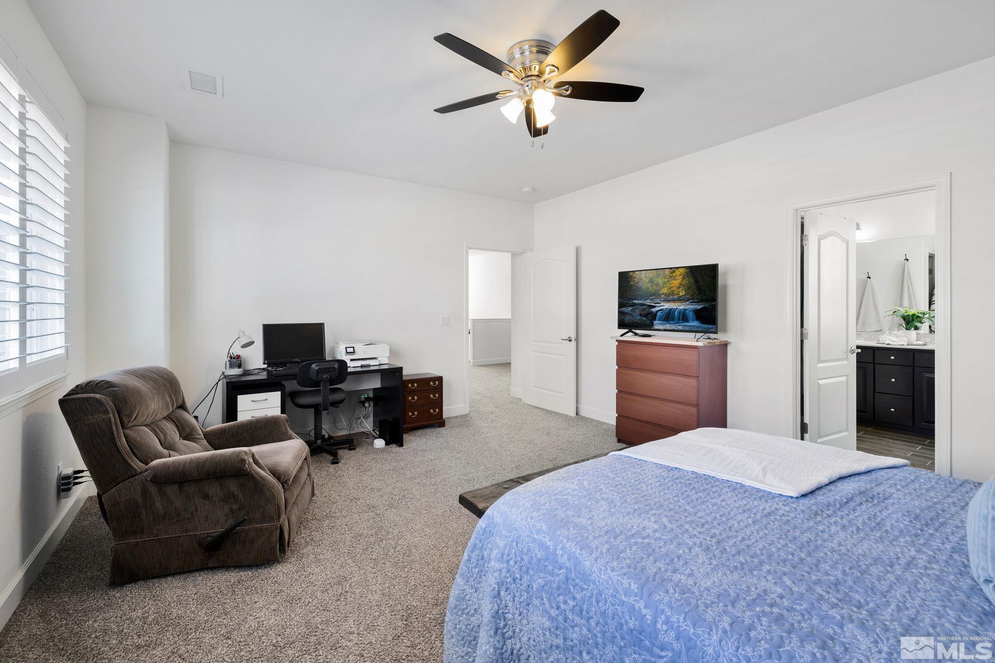 10656 Foxberry Park Drive Reno, NV 89521 - Photo 16 of 31 a bedroom with a bed furniture and a flat screen tv
