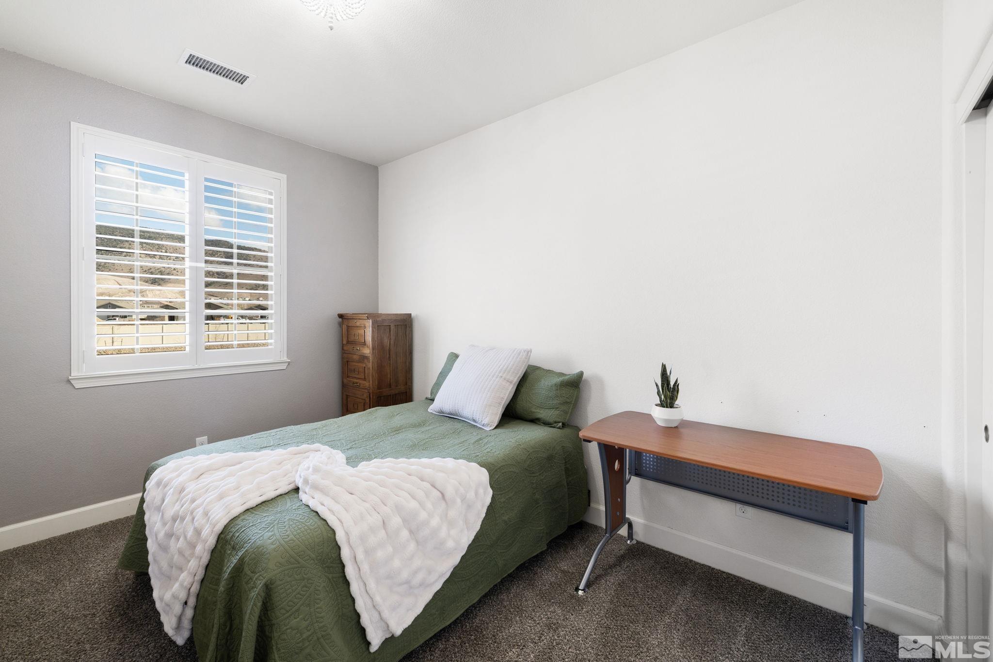 10656 Foxberry Park Drive Reno, NV 89521 - Photo 19 of 31 a bedroom with a bed and window
