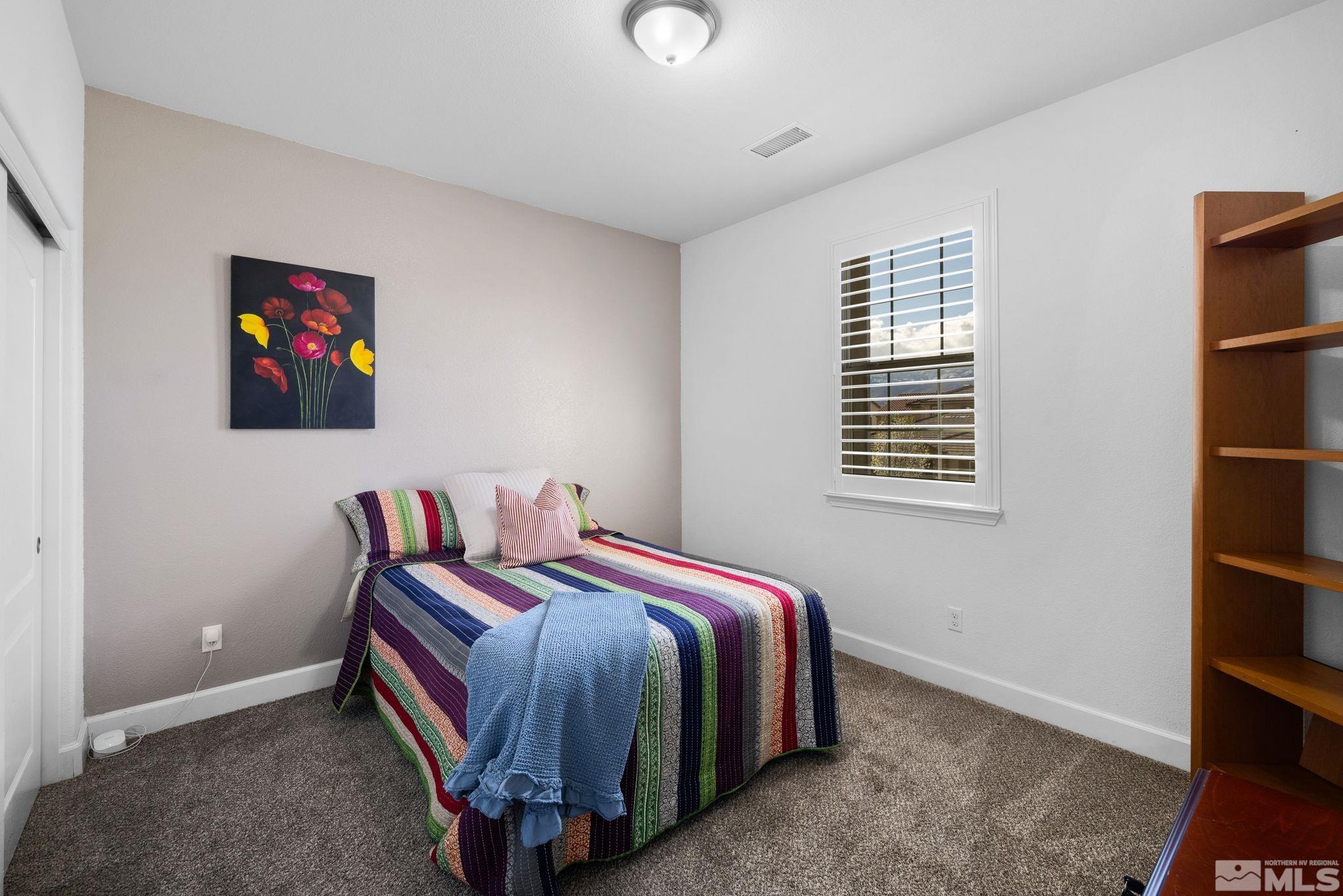 10656 Foxberry Park Drive Reno, NV 89521 - Photo 20 of 31 a bedroom with a bed and a window
