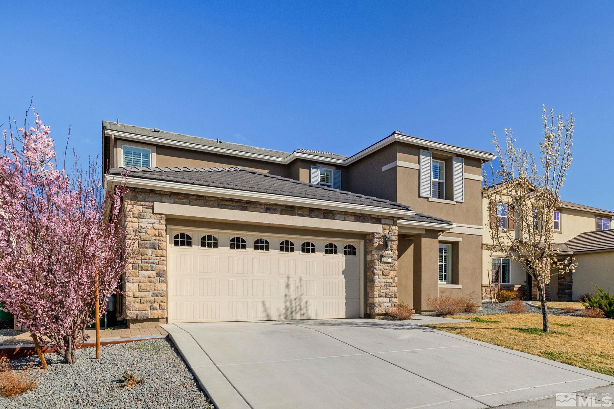 10656 Foxberry Park Drive Reno, NV 89521 - Photo 2 of 31 a front view of a house with a garden