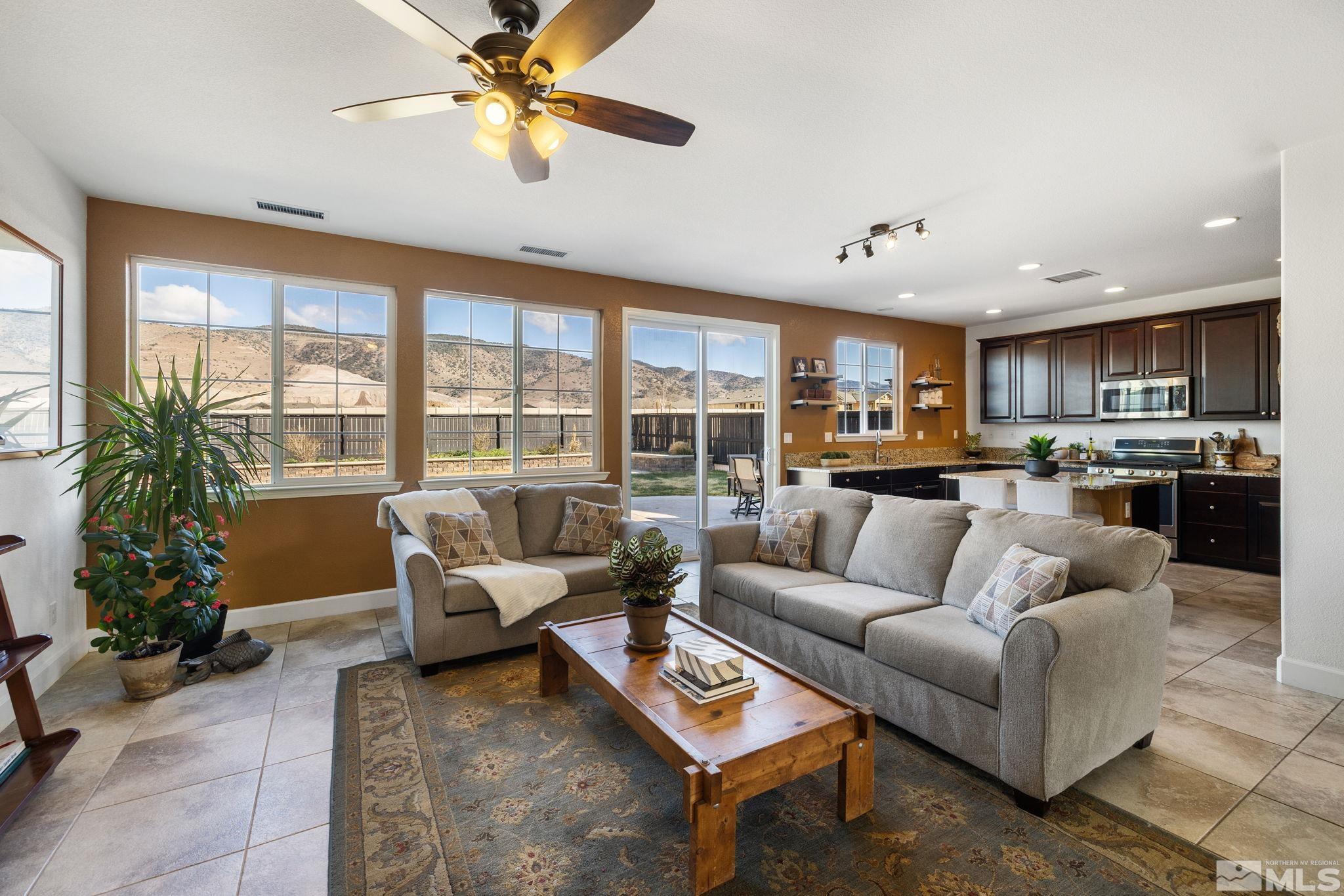 10656 Foxberry Park Drive Reno, NV 89521 - Photo 9 of 31 a living room with furniture and a large window with kitchen view