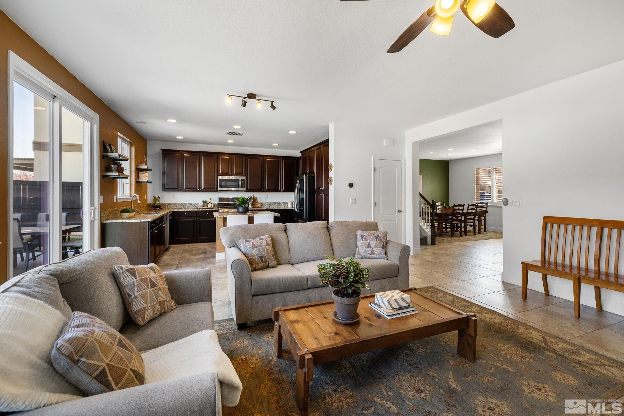 10656 Foxberry Park Drive Reno, NV 89521 - Photo 10 of 31 a living room with furniture kitchen view and a chandelier
