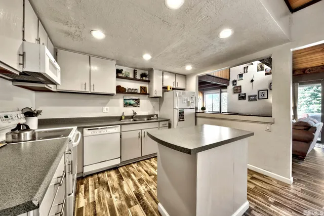 a kitchen with stainless steel appliances granite countertop a sink stove and cabinets
