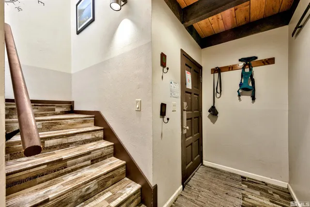 a view of a hallway with wooden floor and entryway