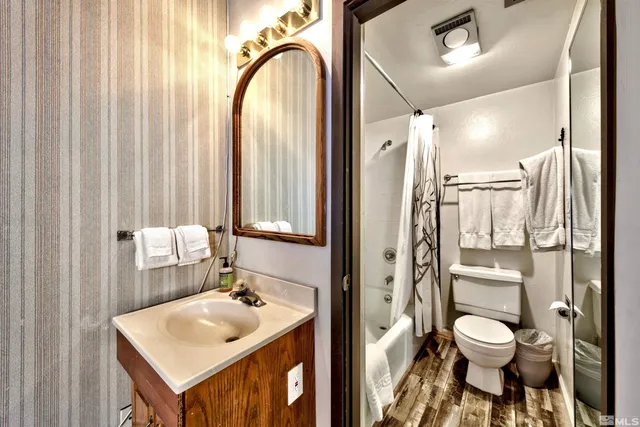 a bathroom with a toilet sink shower and mirror