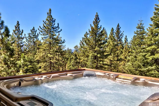 view of roof with tree in the background